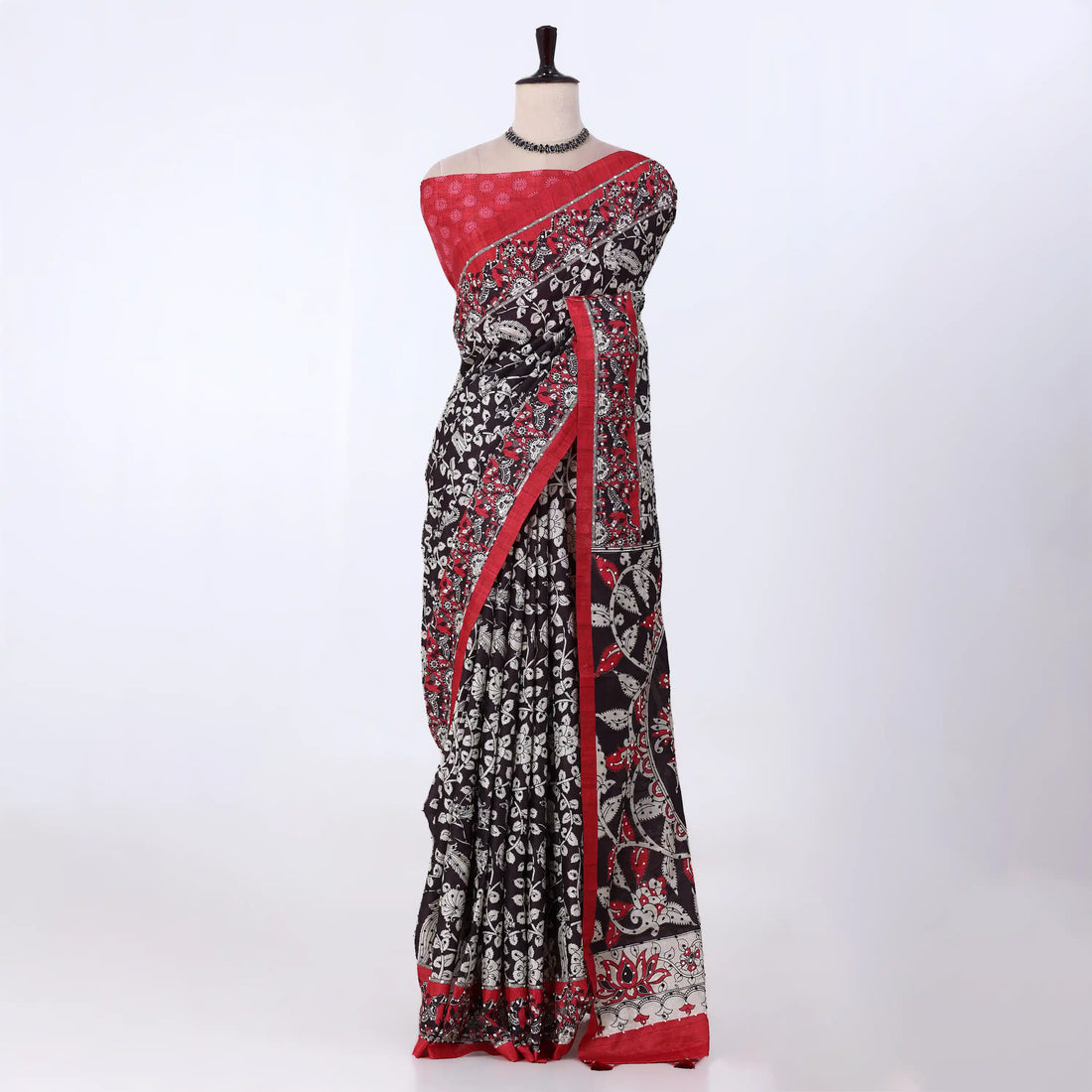 A black and red saree with white floral prints