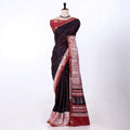 A black and red saree features a black body with red polka dots, a red border, and a white patterned pallu with red accents.