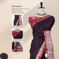 A dark navy or near-black saree with red floral motifs and a red border