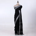 A black saree with a silver-gray border and pallu