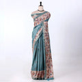 A teal blue and beige printed saree with matching border