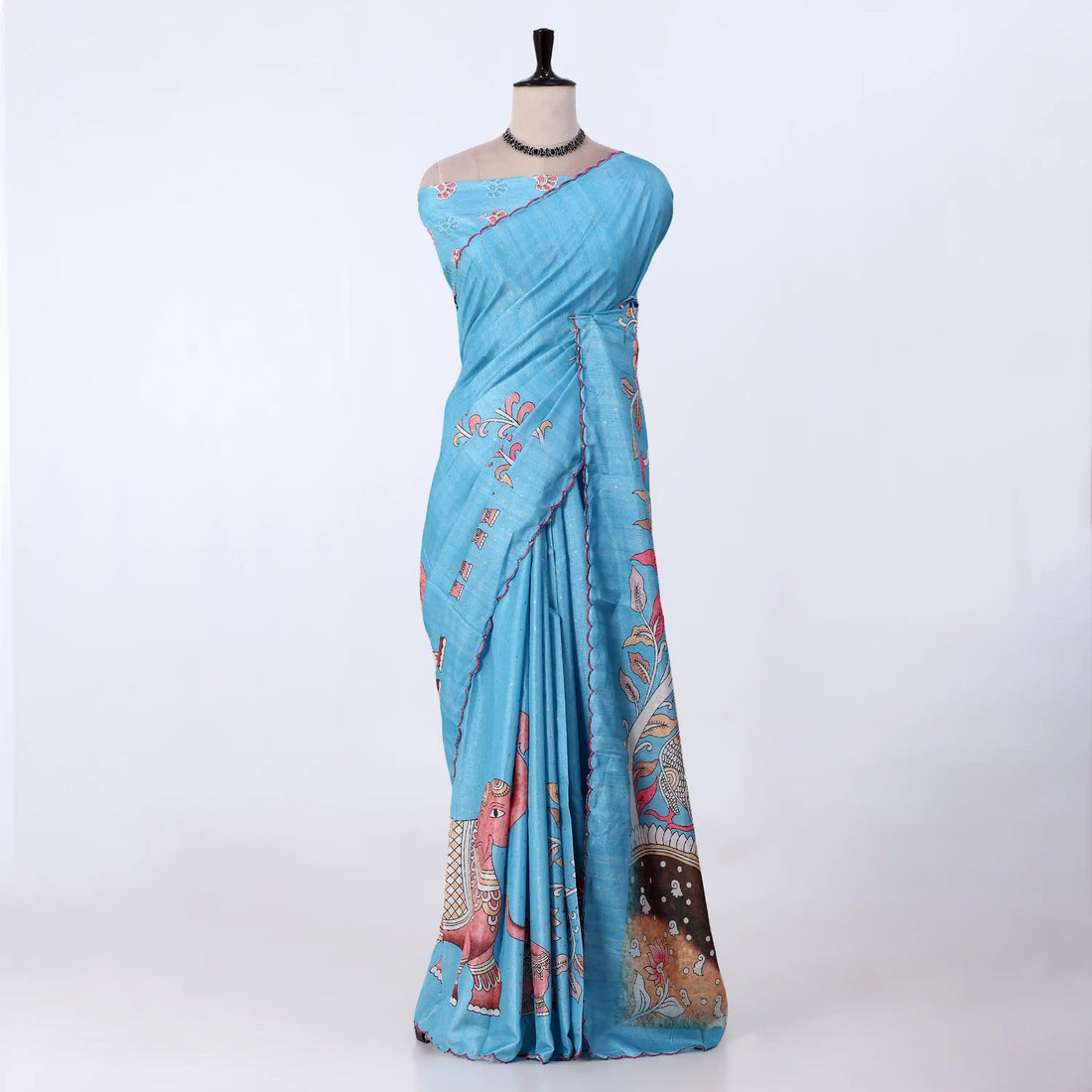 A light blue cotton saree with pink and multicolor traditional prints