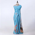 A light blue cotton saree with pink and multicolor traditional prints