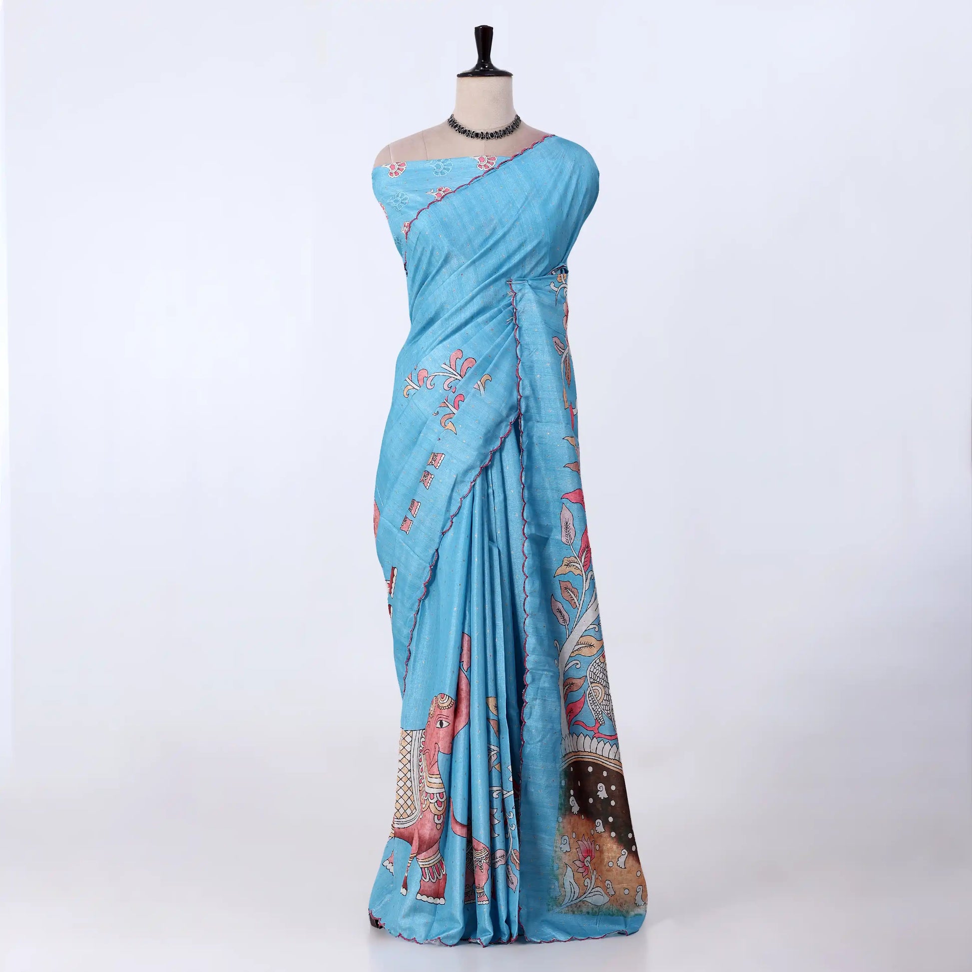 A light blue cotton saree with pink and multicolor traditional prints