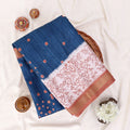 A blue saree with coppery brown borders and white printed patterns