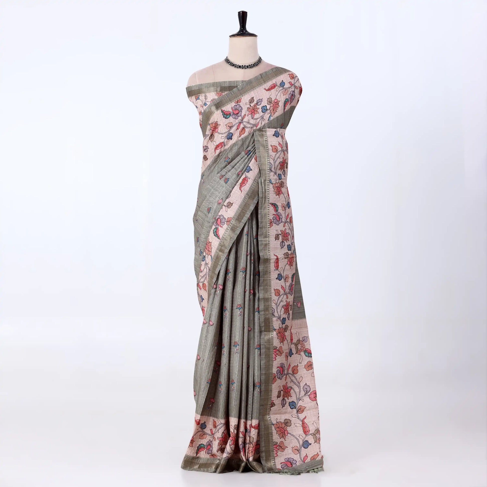 Tusser  saree with muted gray-green base with a pink floral print and a matching border.