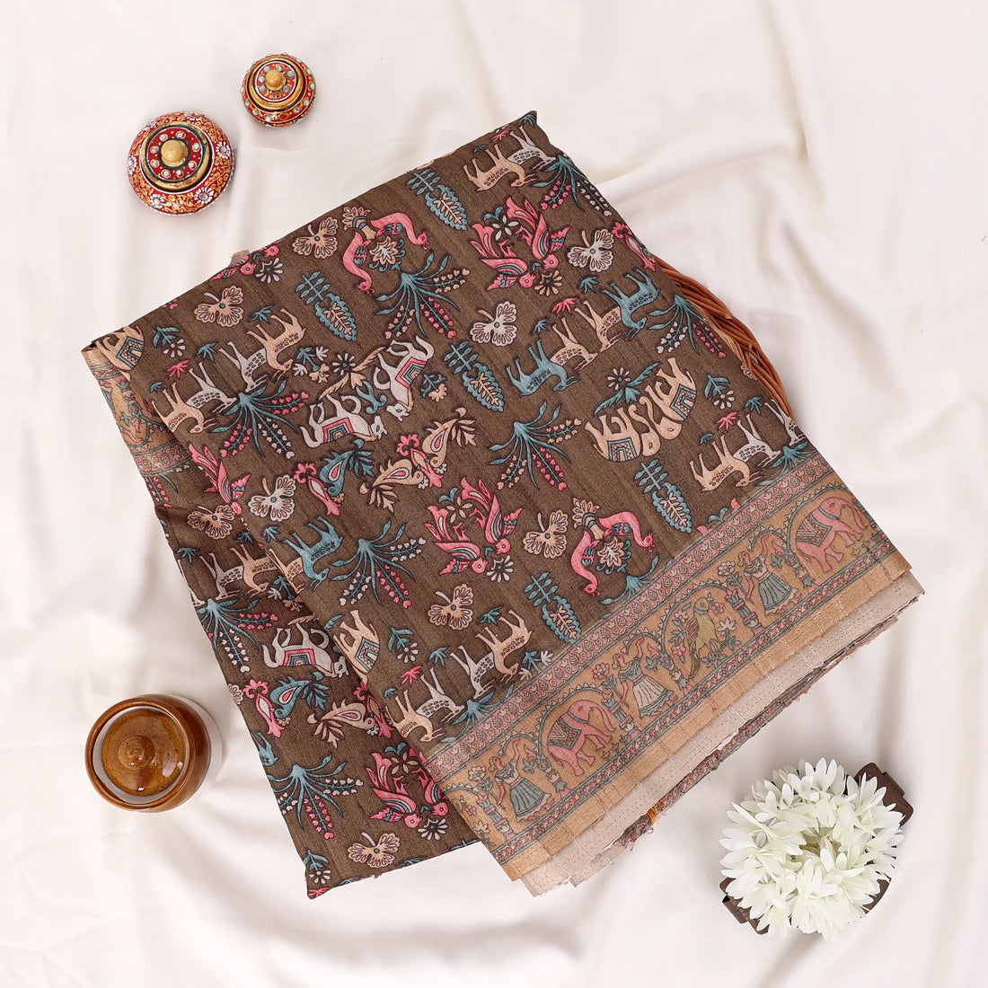 A draped saree with an intricate multicolor floral and geometric pattern