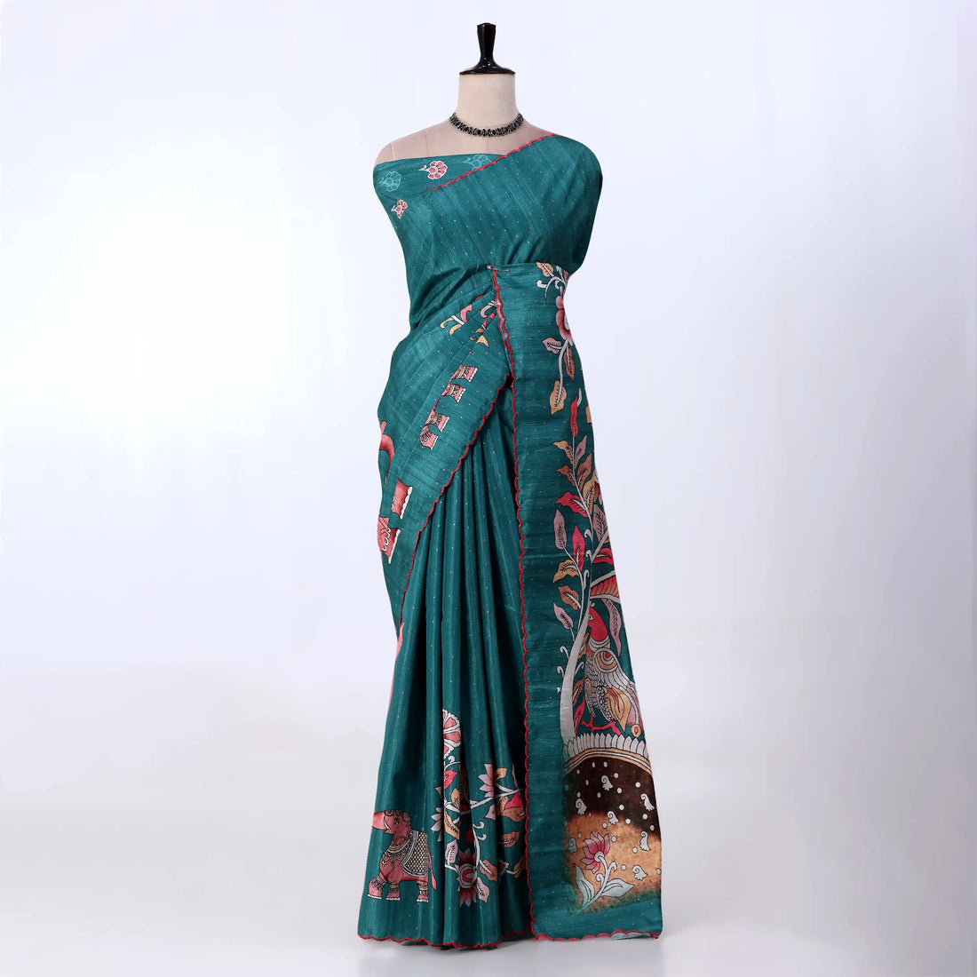 A teal green saree with red and pink floral and bird motifs