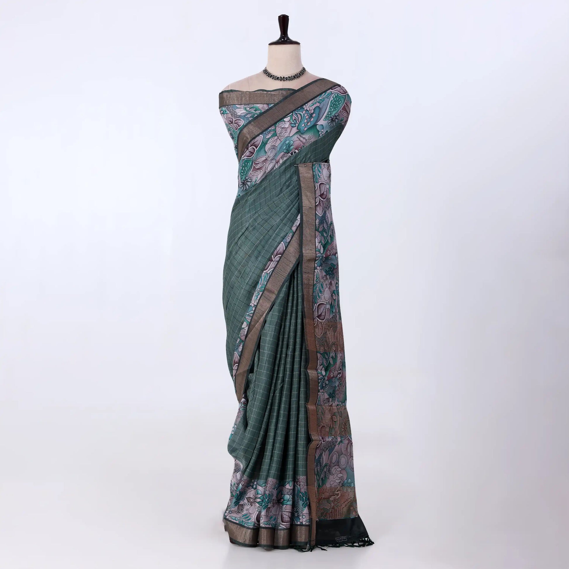 A green and brown printed saree features a sage green body with brown borders