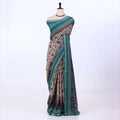 Semi Tussar saree with grey floral printed body and turquoise woven border with decorative pallu.