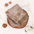 A folded saree with muted taupe floral print top view