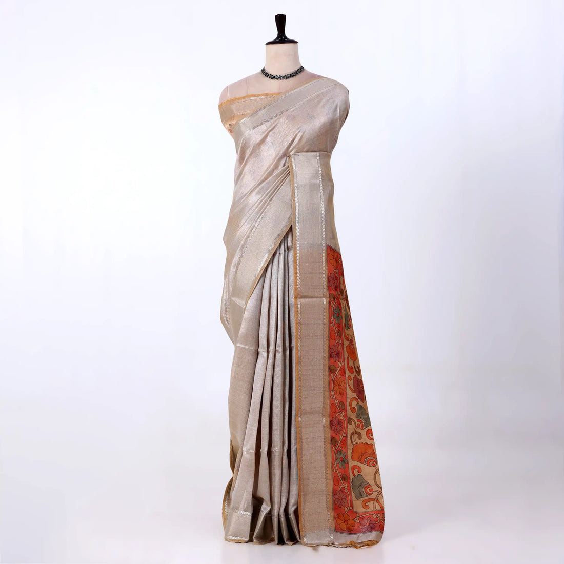 A light beige saree with a vibrant orange and red floral border