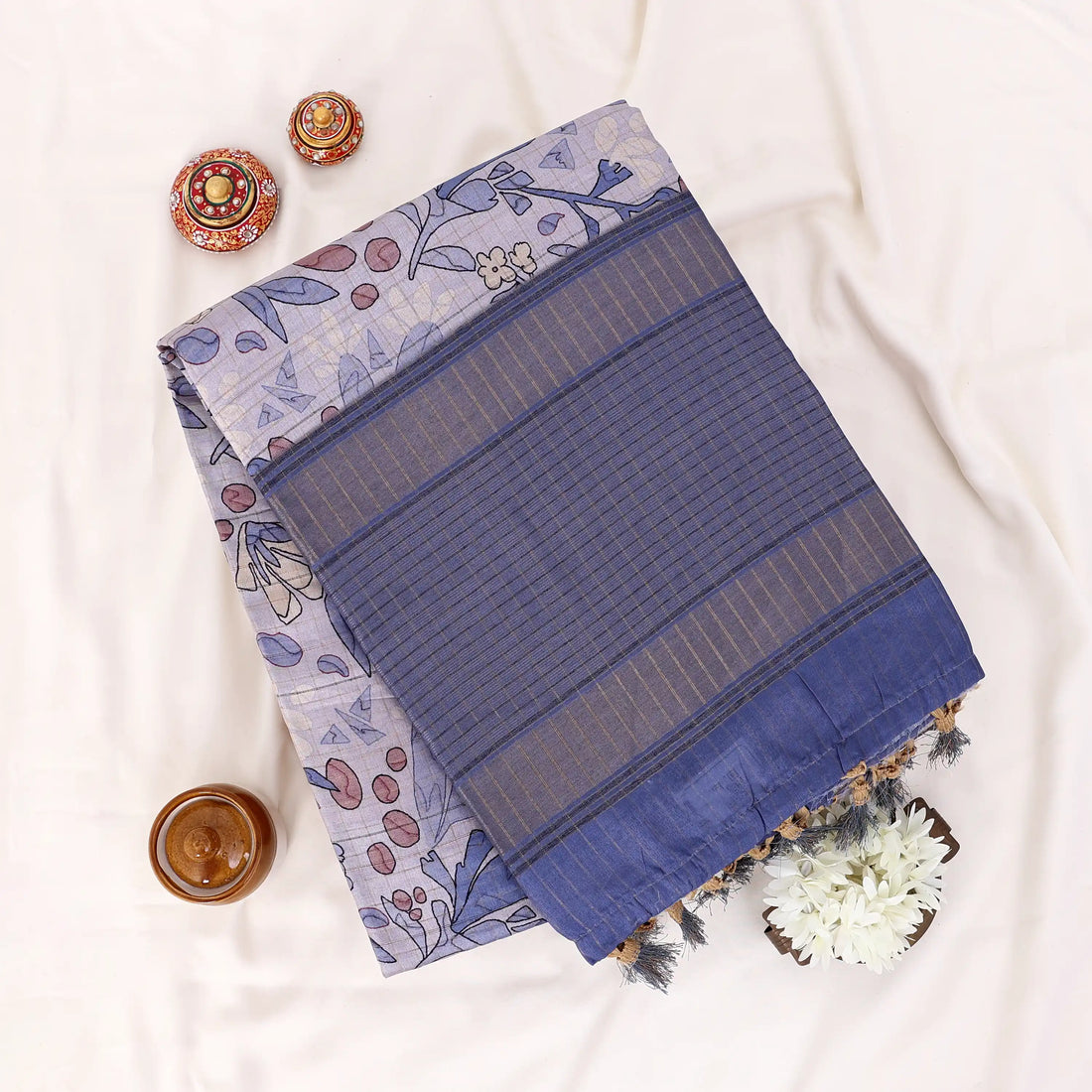 Semi Tussar saree with lavender floral printed body and turquoise woven border with decorative pallu.
