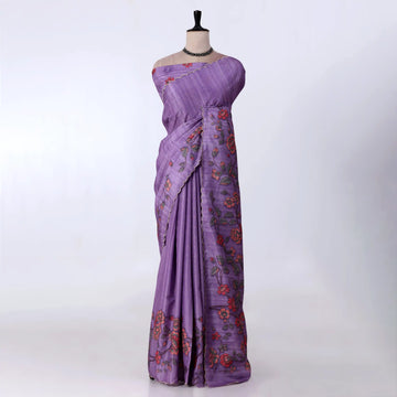 A lavender purple saree with red and orange floral patterns