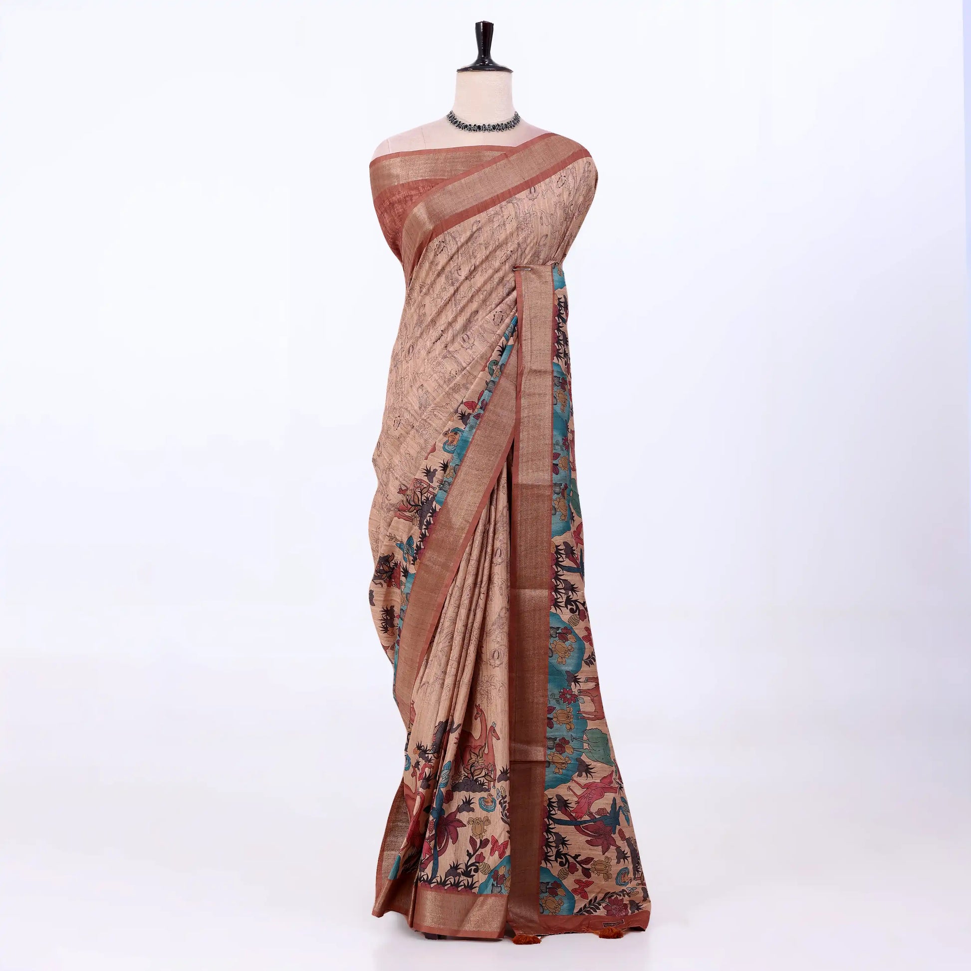 Women's Semi Tussar saree featuring floral print, brown woven border and teal pallu, front display.