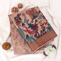 Semi Tussar saree with beige wildlife and floral print, brown woven border, folded flat lay view.