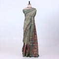 Sage green Semi Tussar saree featuring heritage print with teal woven border, elegant front drape view.