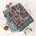 Light green Semi Tussar saree featuring scenic print with dark green woven border, folded view