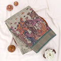Sage green Semi Tussar saree featuring heritage print with teal woven border, elegant folded view.