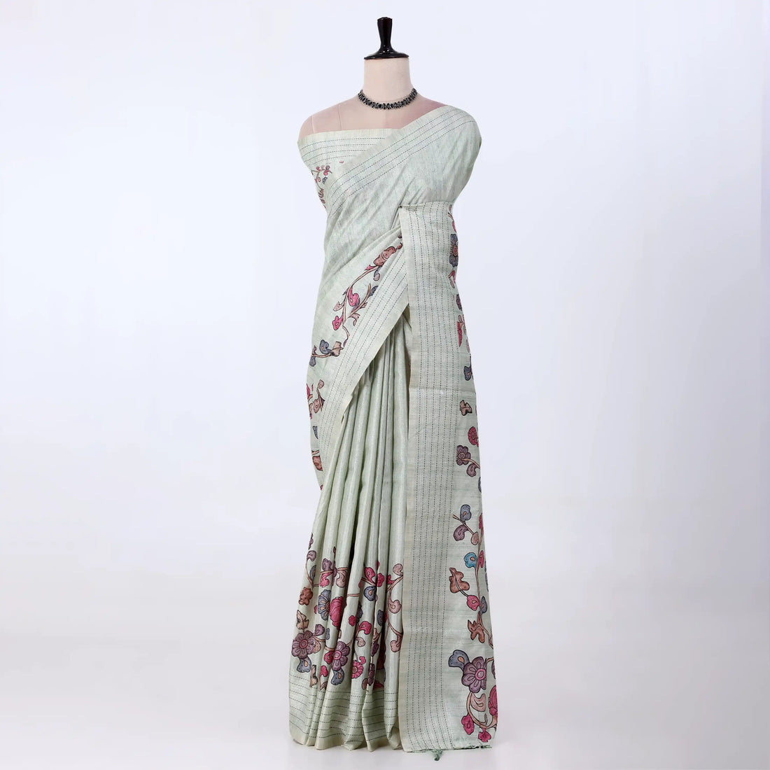 A sage green striped tusser saree with pink and purple floral prints