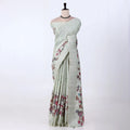 A sage green striped tusser saree with pink and purple floral prints