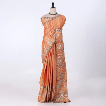 An orange saree with intricate silver and gold floral embroidery