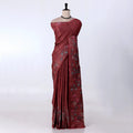 A dark red or maroon saree with floral patterns