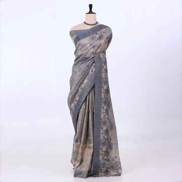 Semi Tussar saree with multi floral printed body and turquoise woven border with decorative pallu.