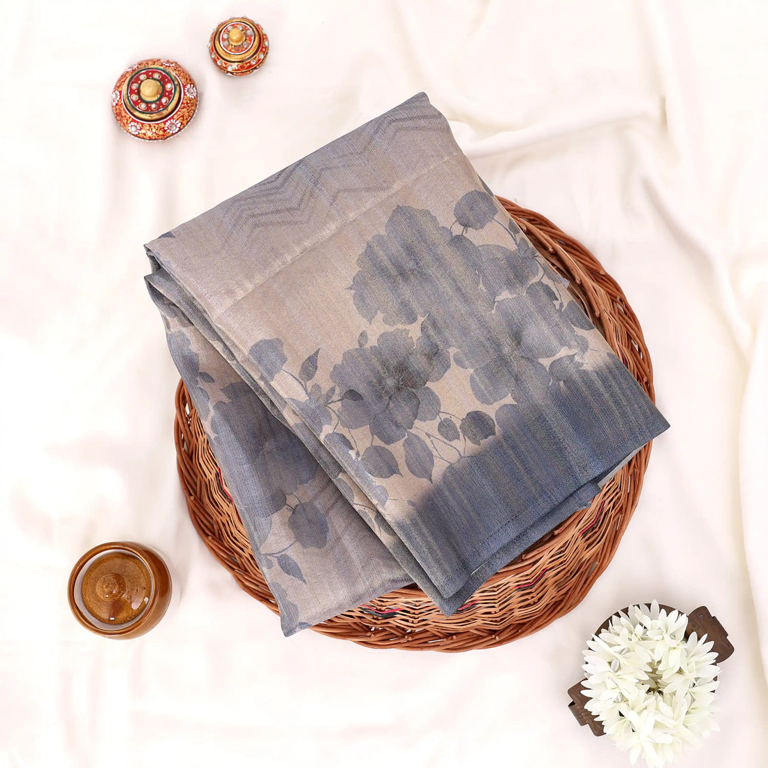 Semi Tussar saree with multi floral printed body and turquoise woven border with decorative pallu.