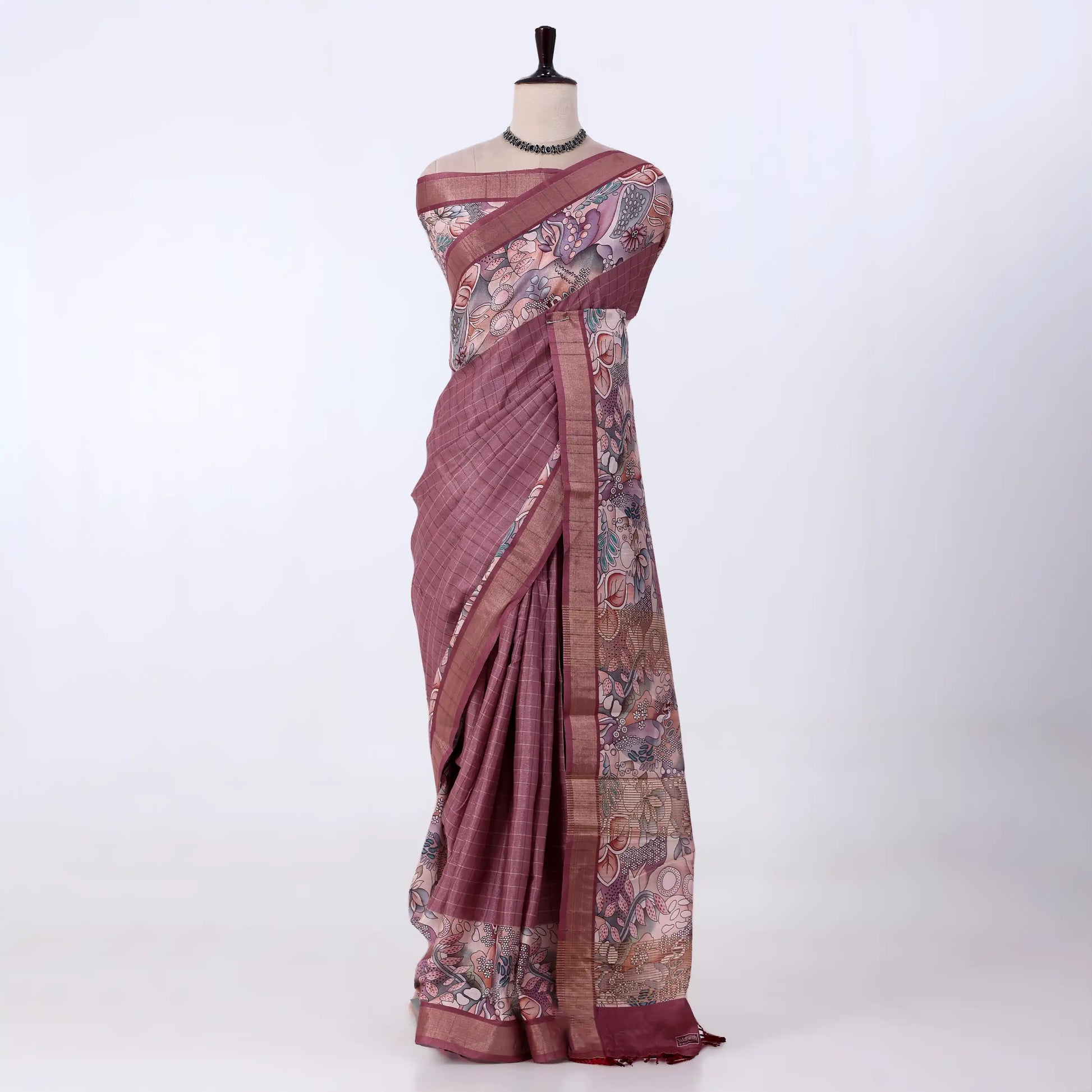 A mauve and pink patterned saree with features a solid mauve border, a floral printed pallu, and a matching printed blouse piece.