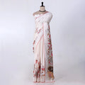 A white and beige printed saree with red border trim and floral motifs