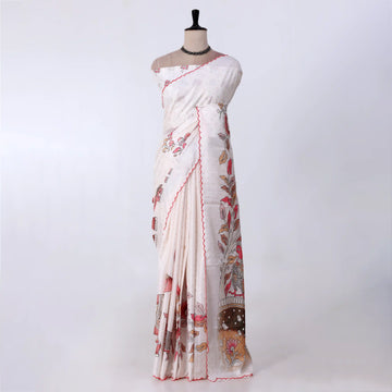 A white and beige printed saree with red border trim and floral motifs
