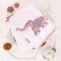 A folded white and beige printed saree with red border trim and floral motifs