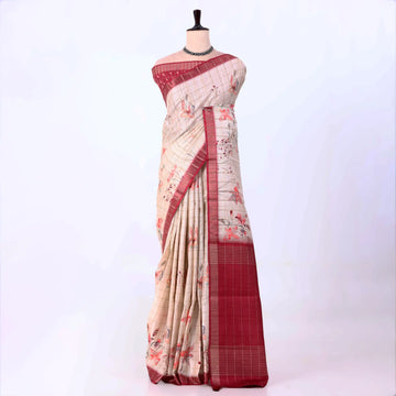 A beige and red saree with floral patterns and a red border