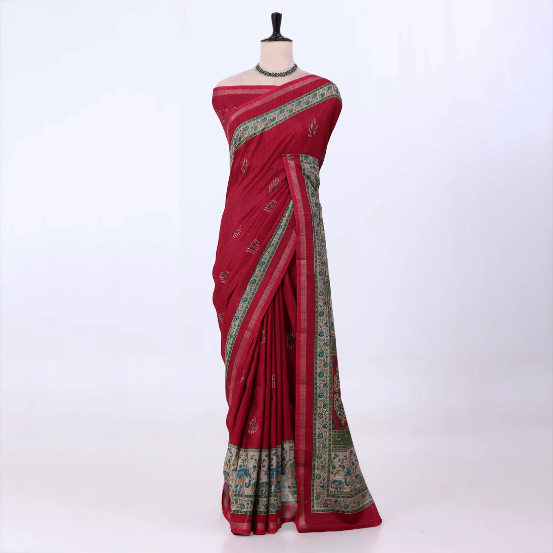 A red cotton saree with green and gold border patterns
