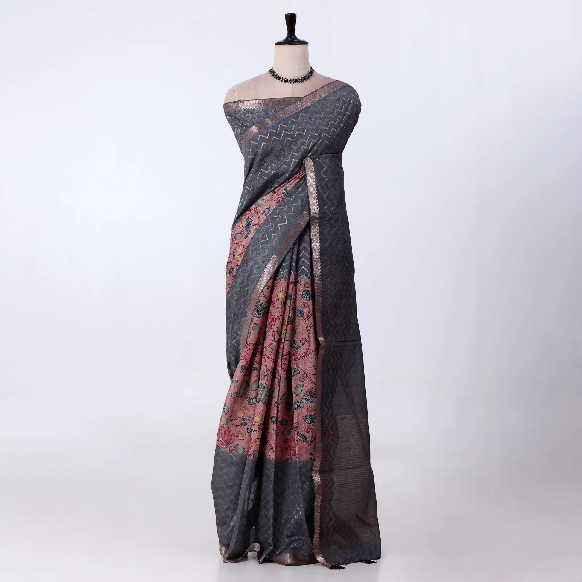 A dark gray and black saree with a pink and multicolor printed border