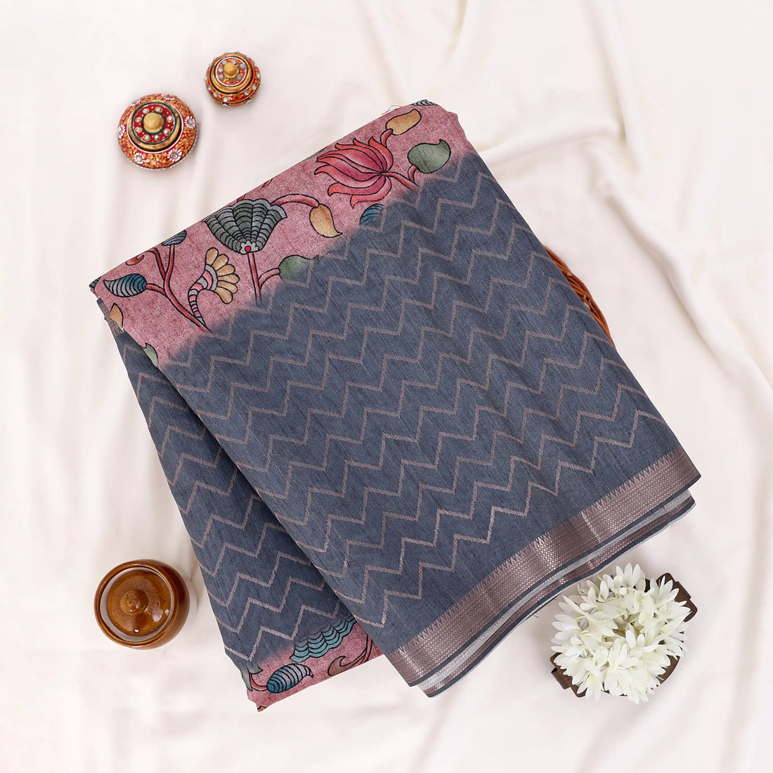 A dark gray and black saree with a pink and multicolor printed border