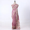 A pink and beige floral printed saree with matching border