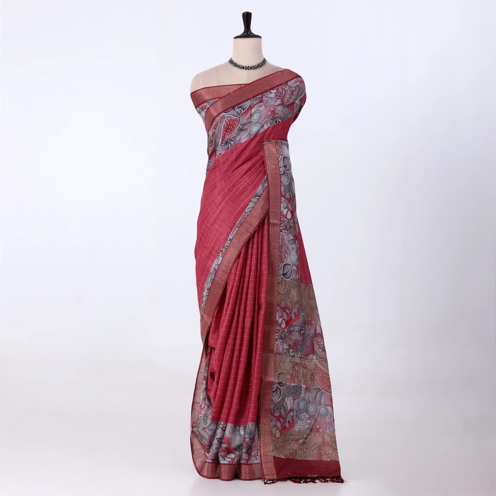 A red and grey printed saree features a sage red body with brown borders