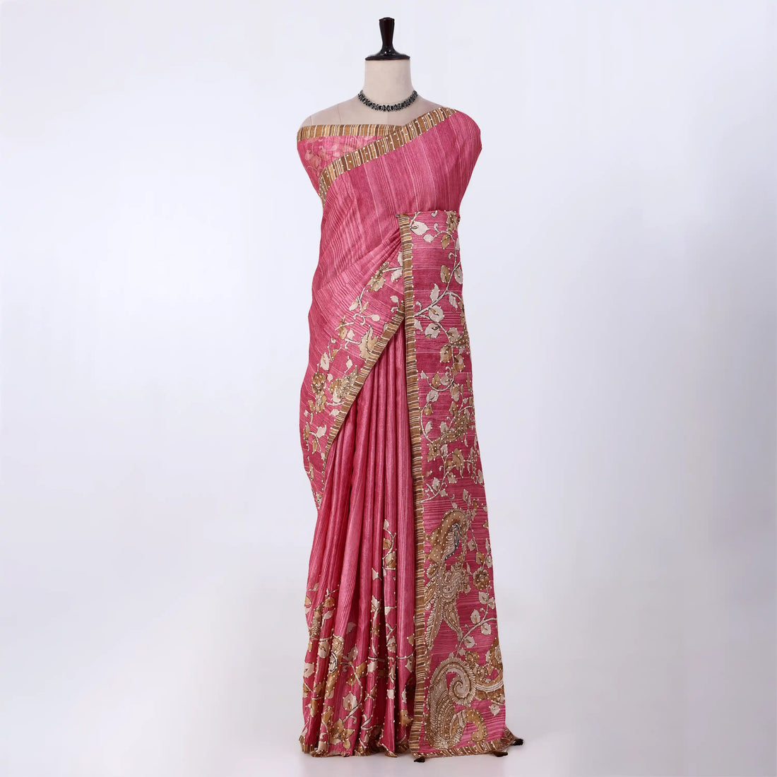 A pink saree with gold and white floral embroidery