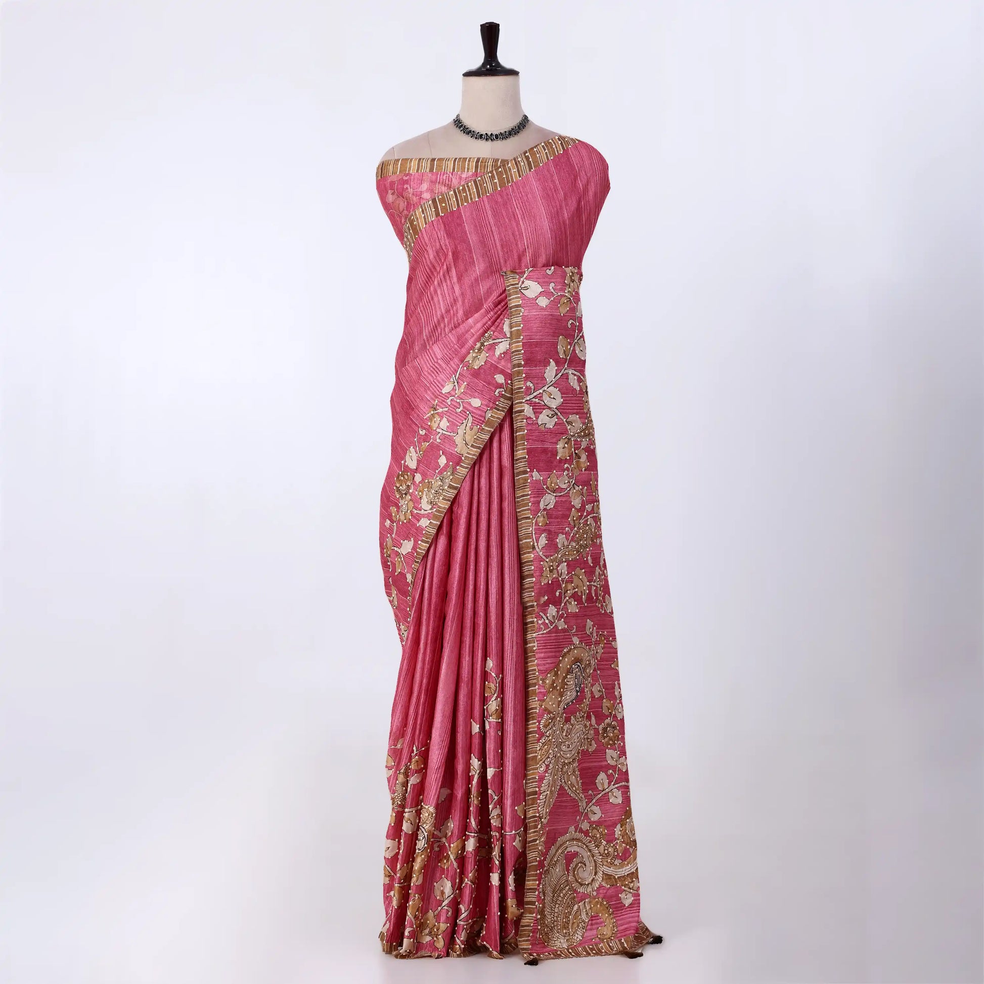 A pink saree with gold and white floral embroidery