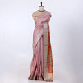 A pink silk saree with a beige border and a rust-orange patterned pallu