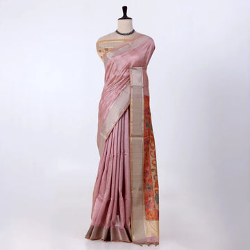 A pink silk saree with a beige border and a rust-orange patterned pallu