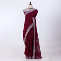 A deep maroon red saree with a silver border