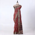 A red and black patterned saree with ornate gold borders