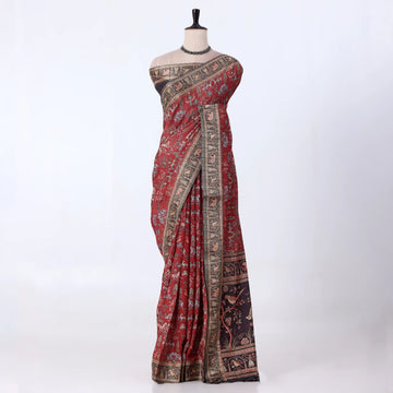 A red and black patterned saree with ornate gold borders