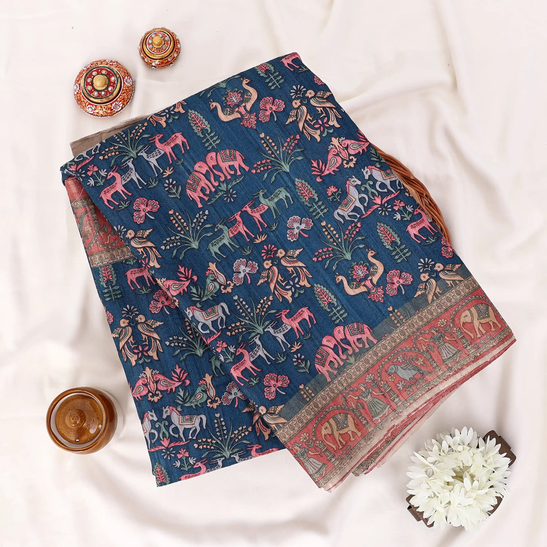 A dark navy blue printed saree with red and beige borders