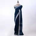 A dark navy blue saree with a silver woven border