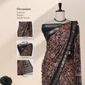 Art silk saree with intricate paisley print and gold zari border in black front draped mannequin view showcasing pallu and blouse