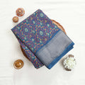 Art silk saree with floral vine jaal pattern and silver zari striped border in blue folded top view display